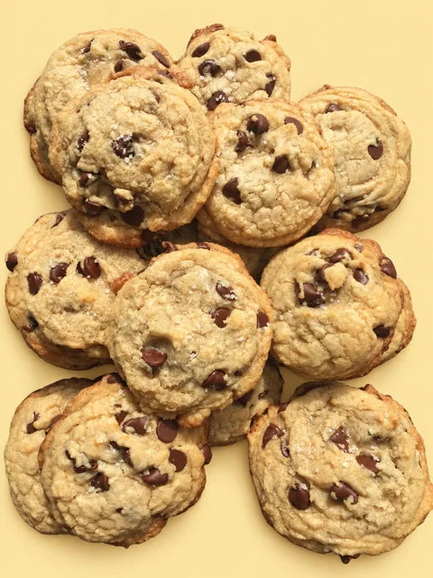 Chocolate chip cookies on a butter-yellow background